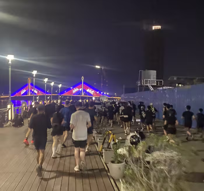 Running club running along the Mekong at night in Phnom Penh